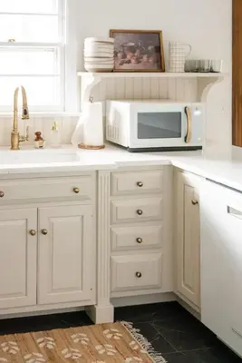 a white kitchen with a microwave on a counter at Wooded Cottage in Elizabethtown with hot tub and sauna in Elizabethtown