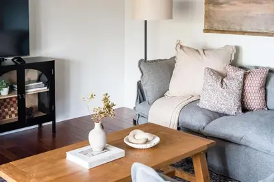 a living room with a couch and a coffee table at Wooded Cottage in Elizabethtown with hot tub and sauna in Elizabethtown