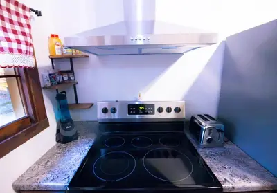 a kitchen with a stove top oven in a kitchen at Rustic Retreat Fireplace, Casino, Camelback Close to everything! in Mount Pocono