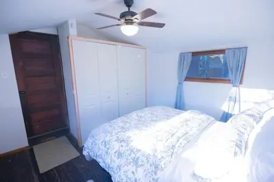 a bedroom with a bed and a ceiling fan at Rustic Retreat Fireplace, Casino, Camelback Close to everything! in Mount Pocono