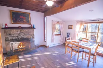 a dining room with a fireplace and a table and chairs at Rustic Retreat Fireplace, Casino, Camelback Close to everything! in Mount Pocono