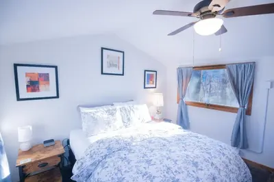 a bedroom with a bed and a ceiling fan at Rustic Retreat Fireplace, Casino, Camelback Close to everything! in Mount Pocono