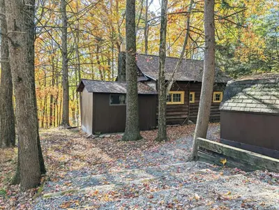 a house in the middle of the woods with trees at Rustic Retreat Fireplace, Casino, Camelback Close to everything! in Mount Pocono