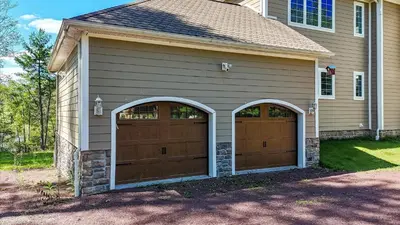 a house with two garage doors in a driveway at VIP Mansion Estate in Blakeslee
