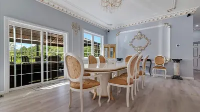 a dining room with a table and chairs at VIP Mansion Estate in Blakeslee