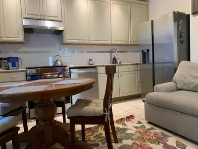 a kitchen with a table and a refrigerator at NYC Apartment by the Harbor in Saint George