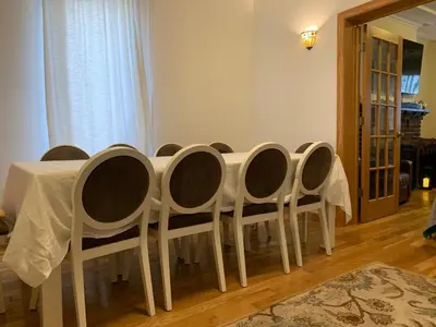 a dining room table with chairs and a white table cloth at NYC Apartment by the Harbor in Saint George