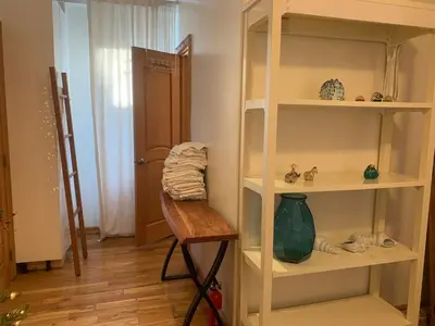 a room with a book shelf and a wooden table at NYC Apartment by the Harbor in Saint George