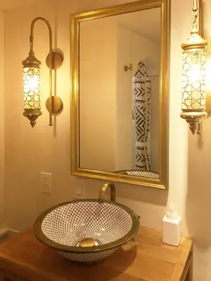 a bathroom with a sink with a mirror and lights at JC Moroccan Hideaway in Jersey City