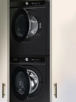 two washers and a dryer in a closet at JC Moroccan Hideaway in Jersey City