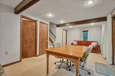 a dining room with a wooden table and chairs at Swiss Chalet in Mount Gretna