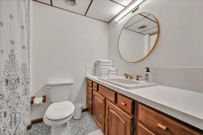 a bathroom with a toilet and a sink and a mirror at Swiss Chalet in Mount Gretna