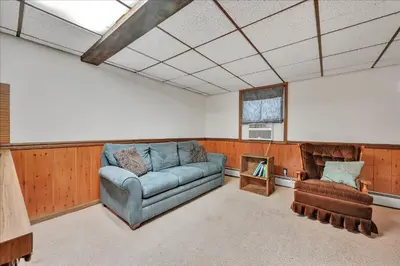 a living room with a couch and a chair at Swiss Chalet in Mount Gretna