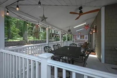 a patio with a table and chairs on a porch at Muhlenberg Cottage in Mount Gretna