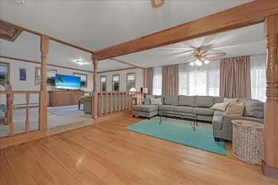 a living room with a couch and a flat screen tv at Muhlenberg Cottage in Mount Gretna