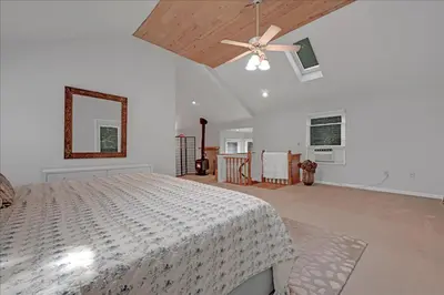 a bedroom with a bed and a ceiling fan at Muhlenberg Cottage in Mount Gretna