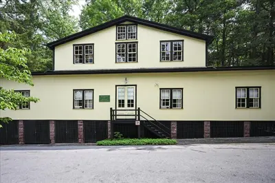 a white house with black windows and a driveway at Muhlenberg Cottage in Mount Gretna
