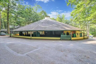 a small yellow building with a thatched roof at Muhlenberg Cottage in Mount Gretna