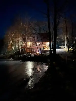 a building at night with lights in the snow at Pocono Mountain Retreat in Cresco