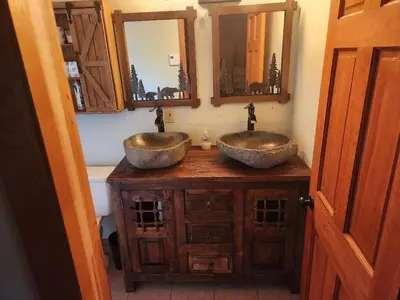 two sinks on a wooden counter in a bathroom at Pocono Mountain Retreat in Cresco