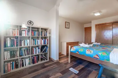 a bedroom with a bed and book shelves filled with books at Hidden Gem Best Views Unbeatable Seclusion etc in Albrightsville