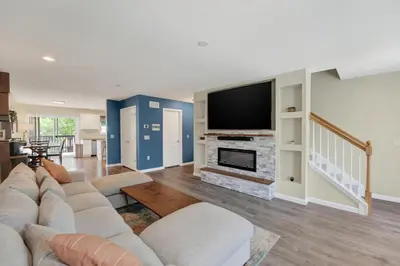 a living room with a couch and a tv at Chic Modern Townhouse 4BR 4B in Wilmington