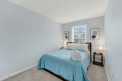 a bedroom with a bed and a window at Chic Modern Townhouse 4BR 4B in Wilmington