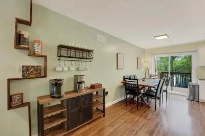 a kitchen and dining room with a table and chairs at Chic Modern Townhouse 4BR 4B in Wilmington