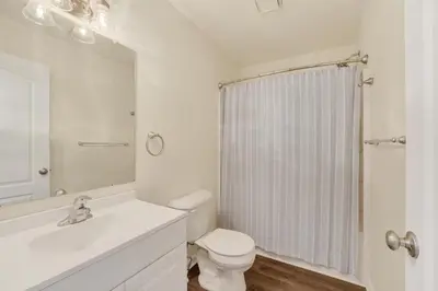 a white bathroom with a toilet and a shower at Chic Modern Townhouse 4BR 4B in Wilmington