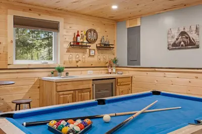 a pool table in a kitchen with wooden walls at Lazy Bear Retreat Outdoor Oasis Hot Tub etc in Blakeslee