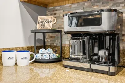 a counter with two coffee cups and a coffee maker at Lazy Bear Retreat Outdoor Oasis Hot Tub etc in Blakeslee