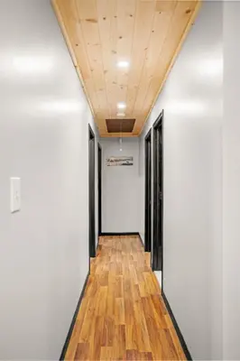a hallway with white walls and a wooden ceiling at Lazy Bear Retreat Outdoor Oasis Hot Tub etc in Blakeslee