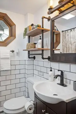 a bathroom with a sink and a toilet and a mirror at Mountain Oasis Hot Tub Game Room Fire Pit in Pocono Summit