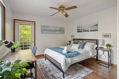 a bedroom with a bed and a ceiling fan at Mountain Oasis Hot Tub Game Room Fire Pit in Pocono Summit