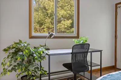 a desk with a lamp and a chair in a room at Mountain Oasis Hot Tub Game Room Fire Pit in Pocono Summit