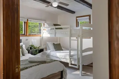 a bedroom with two bunk beds and a ceiling at Mountain Oasis Hot Tub Game Room Fire Pit in Pocono Summit