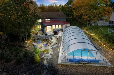 an overhead view of a greenhouse in front of a house at Serene Whitetail Retreat Entertainment Galore in Long Pond