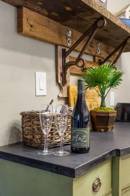 a bottle of wine and two wine glasses on a counter at Serene Whitetail Retreat Entertainment Galore in Long Pond