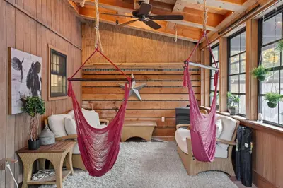 two hammocks hanging from the ceiling in a room at Serene Whitetail Retreat Entertainment Galore in Long Pond
