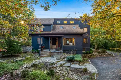 a blue house with a driveway at Serene Whitetail Retreat Entertainment Galore in Long Pond