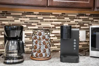 a kitchen counter with a coffee maker and a blender at Cozy Cinema Cabin - Hot Tub and More in Blakeslee