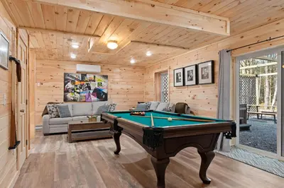 a living room with a pool table in it at Cozy Cinema Cabin - Hot Tub and More in Blakeslee