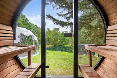 a view from the inside of a house with windows at The Lazy Bear Cabin Dome Hot Tub Sauna & More in Albrightsville