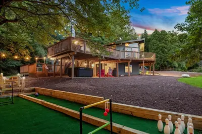 a house with a mini golf course in front of it at The Lazy Bear Cabin Dome Hot Tub Sauna & More in Albrightsville