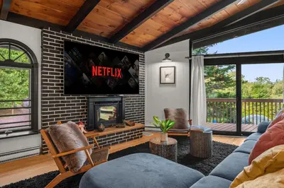 a living room with a couch and a fireplace at The Lazy Bear Cabin Dome Hot Tub Sauna & More in Albrightsville