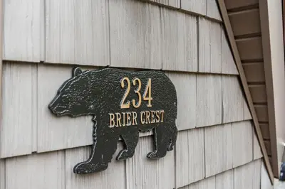 a black bear sign on the side of a building at Whispering Pines - Lake Access Hot Tub Fire Pit in Blakeslee