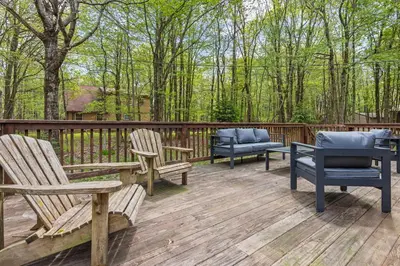 a deck with three chairs and benches on it at Whispering Pines - Lake Access Hot Tub Fire Pit in Blakeslee