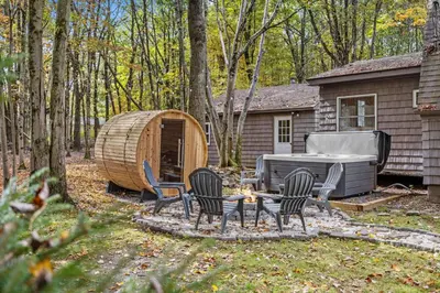 a backyard with a tent and chairs and a grill at Whispering Pines - Lake Access Hot Tub Fire Pit in Blakeslee