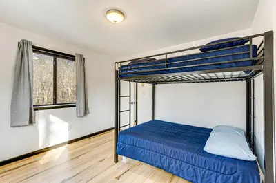a bedroom with two bunk beds and a window at Hot Tub and Game Room Long Pond Getaway! in Long Pond