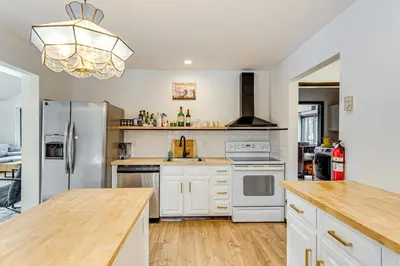 a kitchen with white appliances and a wooden counter top at Hot Tub and Game Room Long Pond Getaway! in Long Pond
